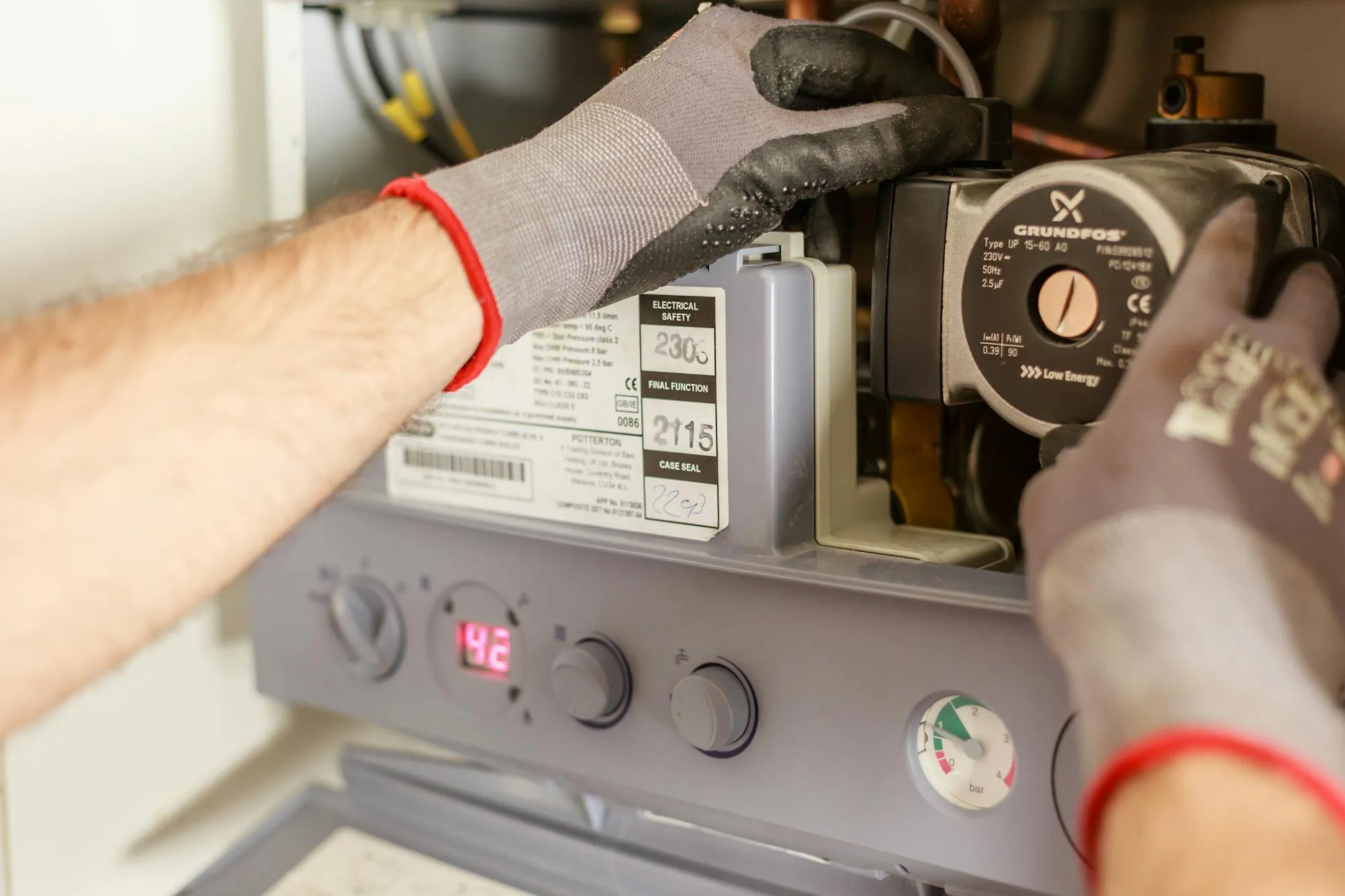 Gas engineer servicing a domestic boiler in a Coventry home.